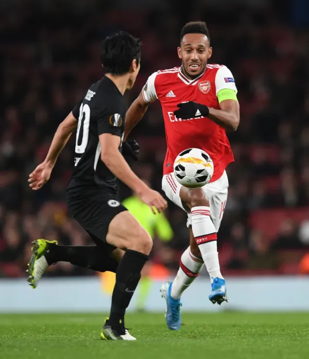 Framed Print : Arsenal's Aubameyang Clashes with Eintracht Frankfurt's Hasebe in Europa League Showdown Framed Print : Arsenal's Aubameyang Clashes with Eintracht Frankfurt's Hasebe in Europa League Showdown