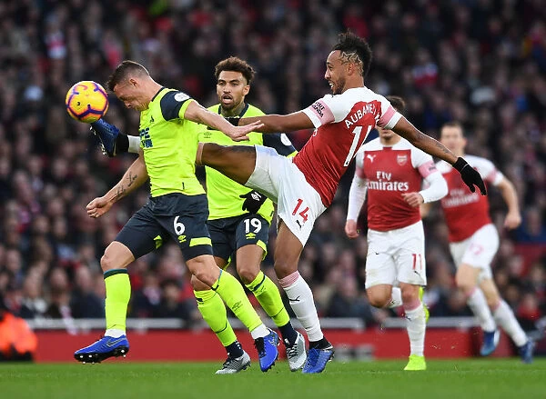 Arsenal's Aubameyang Clashes with Huddersfield's Hogg in Premier League Showdown