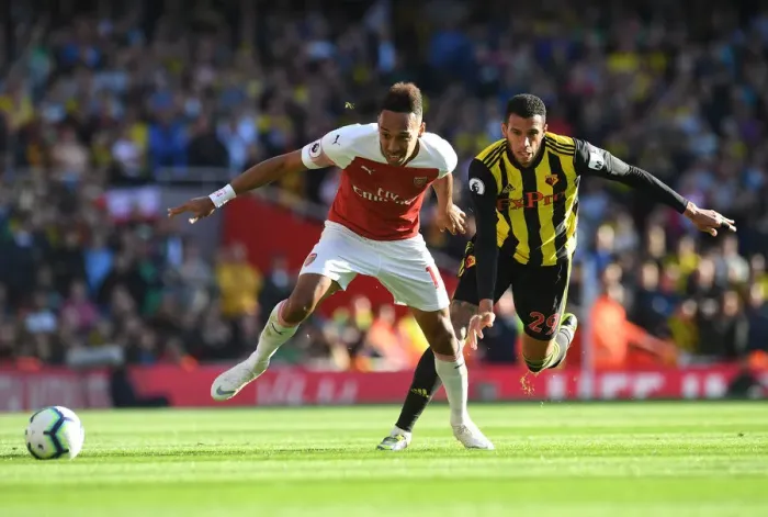 Framed Print : Arsenal's Aubameyang Clashes with Watford's Capoue in Premier League Showdown