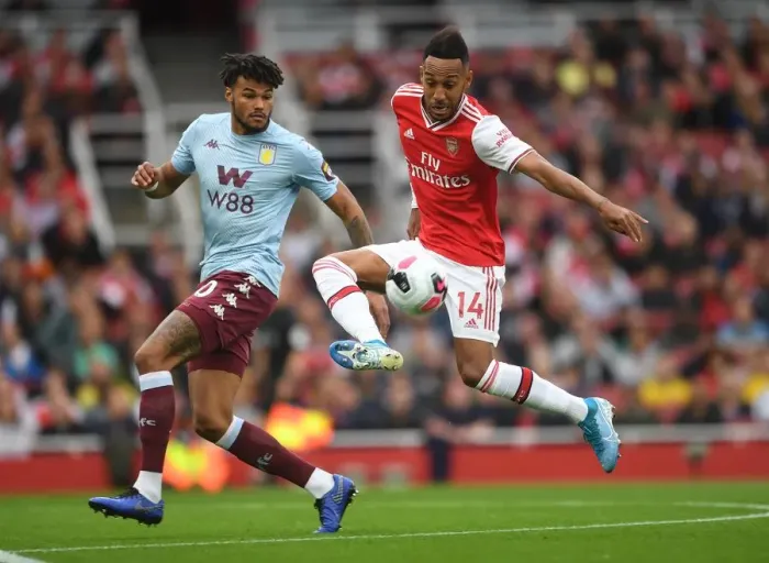 Framed Print : Arsenal's Aubameyang Faces Off Against Villa's Mings in Intense Premier League Clash