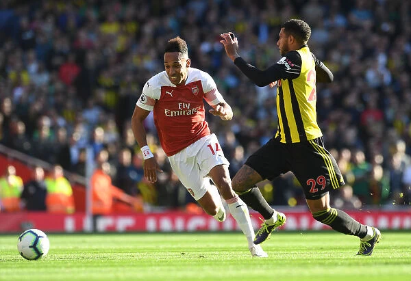 Arsenal's Aubameyang Faces Off Against Watford's Capoue in Premier League Clash