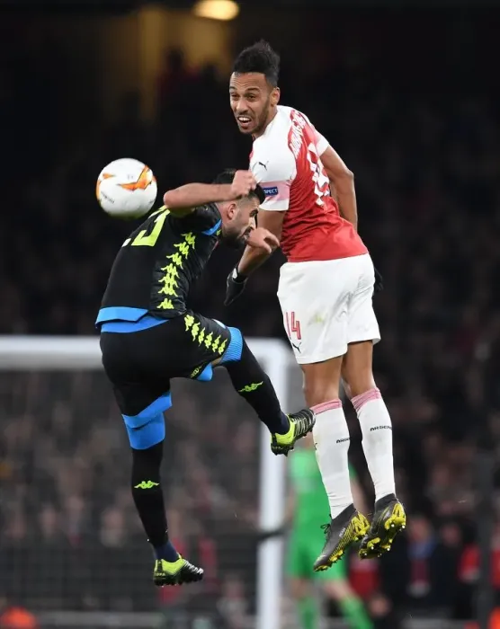 Framed Print : Arsenal's Aubameyang Leaps Past Napoli's Hysaj in Europa League Quarterfinal Clash Framed Print : Arsenal's Aubameyang Leaps Past Napoli's Hysaj in Europa League Quarterfinal Clash