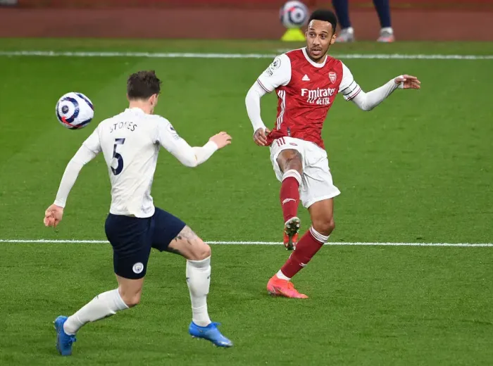 Framed Print : Arsenal's Aubameyang Outmaneuvers Manchester City's Stones: A Behind-Closed-Doors Battle in the Premier League Framed Print : Arsenal's Aubameyang Outmaneuvers Manchester City's Stones: A Behind-Closed-Doors Battle in the Premier League