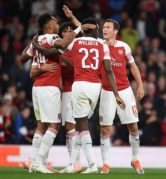 Arsenal's Aubameyang, Welbeck, and Lichtsteiner Celebrate Goals Against Vorskla Poltava in Europa League