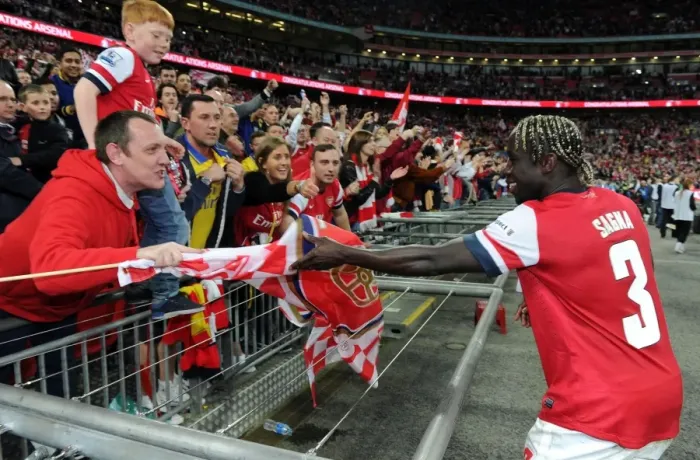 Framed Print : Arsenal's Bacary Sagna Embraces Fan with Team Flag after FA Cup Semi-Final Victory Framed Print : Arsenal's Bacary Sagna Embraces Fan with Team Flag after FA Cup Semi-Final Victory