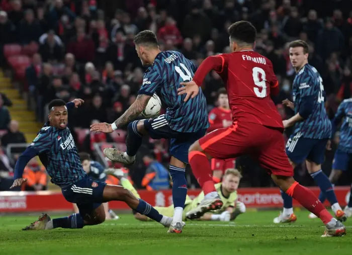 Framed Print : Arsenal's Ben White Bravely Blocks Roberto Firmino's Shot in Carabao Cup Semi-Final Clash vs Liverpool Framed Print : Arsenal's Ben White Bravely Blocks Roberto Firmino's Shot in Carabao Cup Semi-Final Clash vs Liverpool