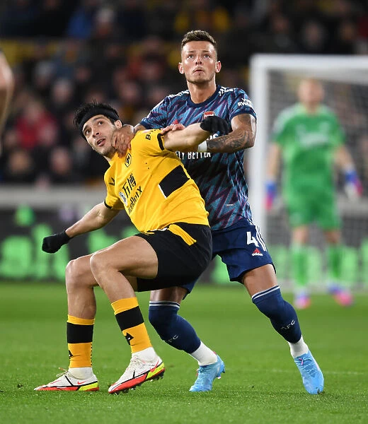 Arsenal's Ben White Fends Off Raul Jimenez in Intense Wolverhampton Wanderers Clash (Premier League 2021-22)