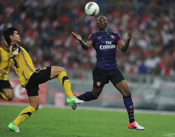 Arsenal's Benik Afobe Faces Off Against Mohd Umar of Malaysia XI