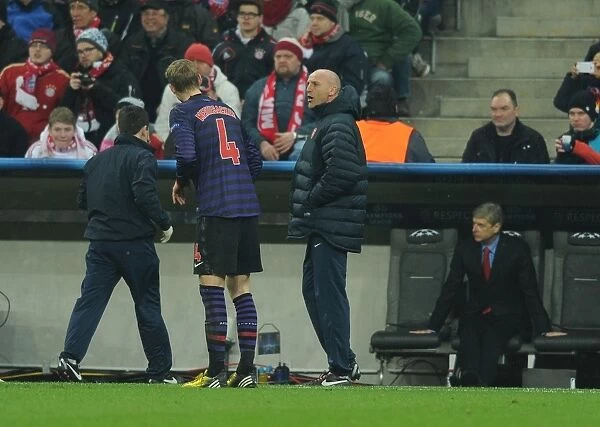 Arsenal's Bould Coaches Mertesacker Amidst Bayern Munich Tension (UEFA Champions League 2012-13)