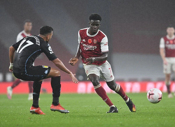 Arsenal's Bukayo Saka in Action: Premier League Showdown at Empty Emirates Stadium (Arsenal vs Aston Villa, 2020-21)