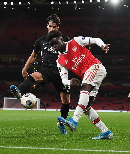 Arsenal's Bukayo Saka Clashes with Eintracht Frankfurt's Gonzalo Paciencia in Europa League Showdown