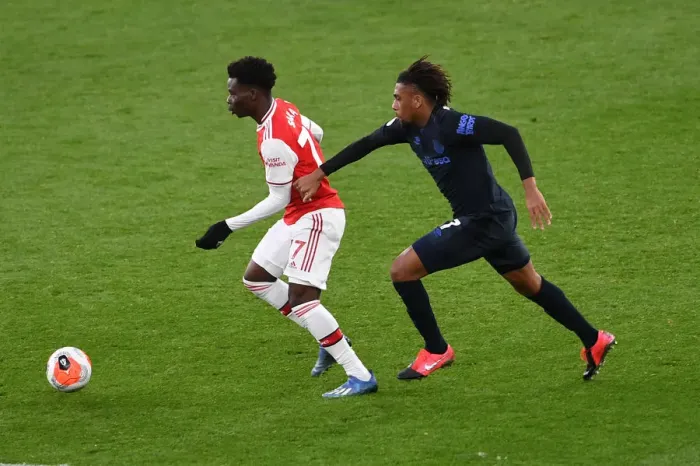 Framed Print : Arsenal's Bukayo Saka Clashes with Everton's Alex Iwobi in Premier League Showdown Framed Print : Arsenal's Bukayo Saka Clashes with Everton's Alex Iwobi in Premier League Showdown