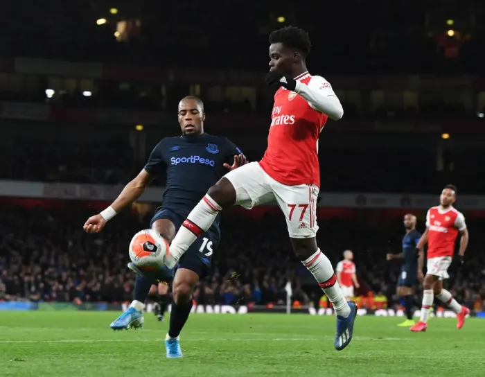 Framed Print : Arsenal's Bukayo Saka Clashes with Everton's Djibril Sidibe in Premier League Showdown Framed Print : Arsenal's Bukayo Saka Clashes with Everton's Djibril Sidibe in Premier League Showdown