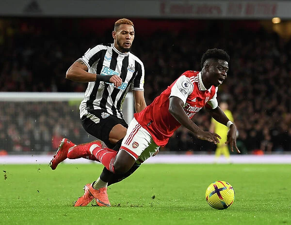 Arsenal's Bukayo Saka Clashes with Newcastle's Joelinton in Premier League Showdown