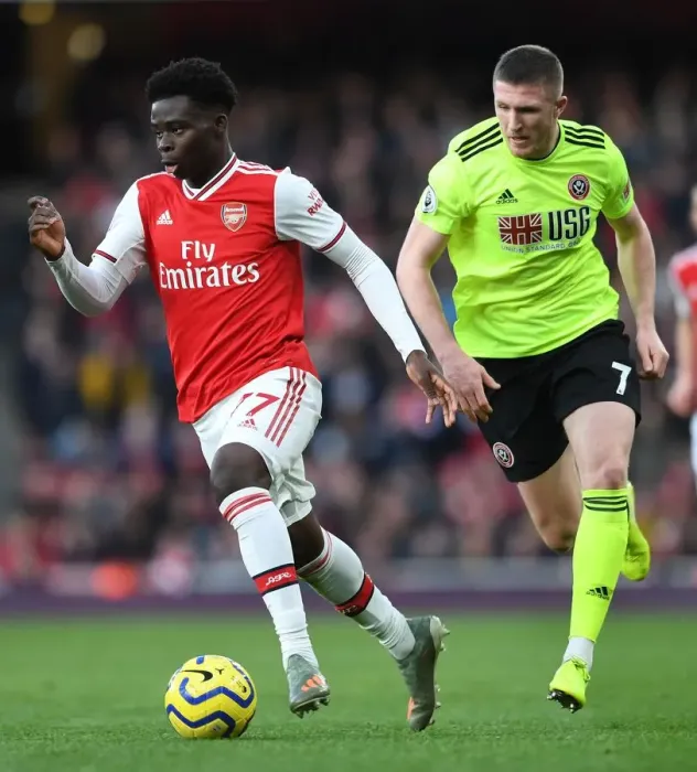 Framed Print : Arsenal's Bukayo Saka Clashes with Sheffield United's John Lundstram in Premier League Showdown Framed Print : Arsenal's Bukayo Saka Clashes with Sheffield United's John Lundstram in Premier League Showdown