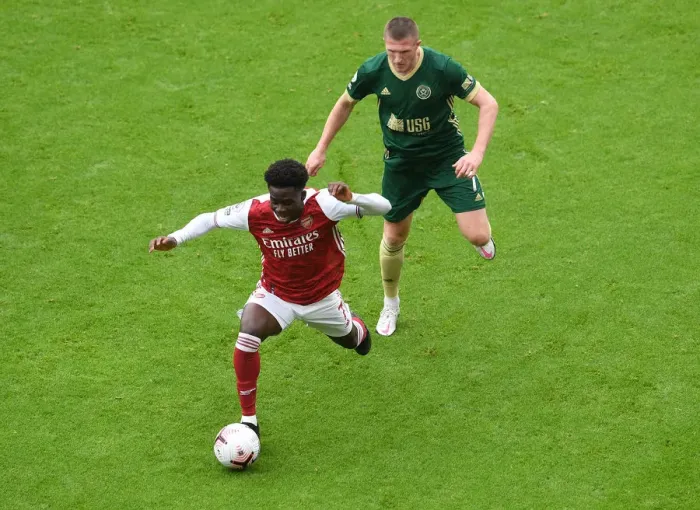 Framed Print : Arsenal's Bukayo Saka Clashes with Sheffield United's John Lundstram in Premier League Showdown Framed Print : Arsenal's Bukayo Saka Clashes with Sheffield United's John Lundstram in Premier League Showdown