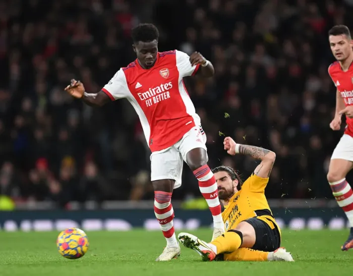 Framed Print : Arsenal's Bukayo Saka Clashes with Wolves Ruben Neves in Premier League Showdown Framed Print : Arsenal's Bukayo Saka Clashes with Wolves Ruben Neves in Premier League Showdown