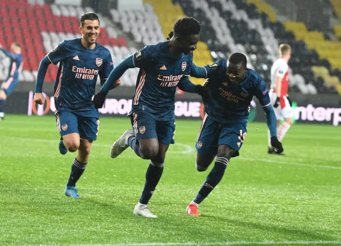 Framed Print : Arsenal's Bukayo Saka, Dani Ceballos, and Nicolas Pepe Celebrate Goals in Empty Eden Arena during Slavia Prague vs Arsenal UEFA Europa League Quarterfinal Framed Print : Arsenal's Bukayo Saka, Dani Ceballos, and Nicolas Pepe Celebrate Goals in Empty Eden Arena during Slavia Prague vs Arsenal UEFA Europa League Quarterfinal
