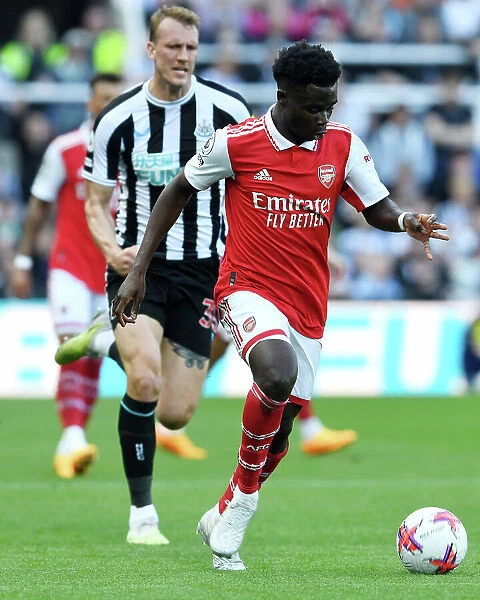Arsenal's Bukayo Saka Drives Past Newcastle's Defense in Premier League Showdown (May 2023)
