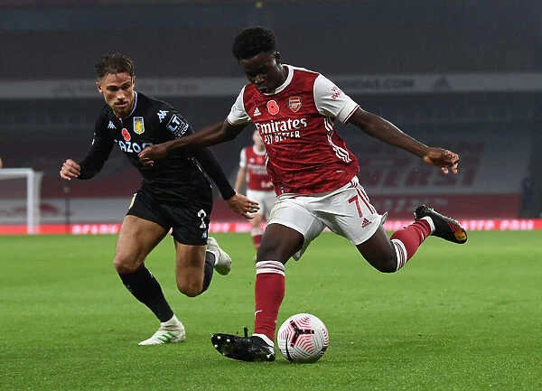 Arsenal's Bukayo Saka Faces Off Against Aston Villa's Matthew Cash in Premier League Clash