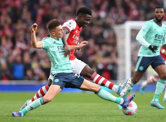 Framed Print : Arsenal's Bukayo Saka Faces Off Against Leicester City's Luke Thomas in Premier League Clash Framed Print : Arsenal's Bukayo Saka Faces Off Against Leicester City's Luke Thomas in Premier League Clash