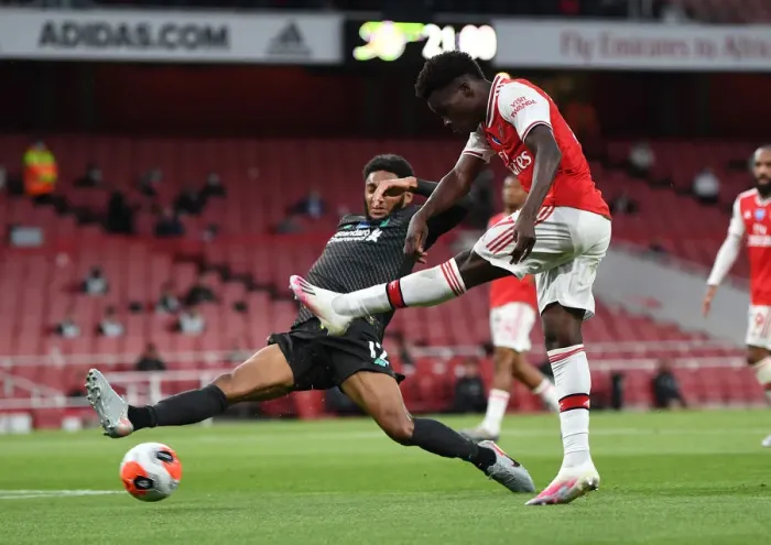 Framed Print : Arsenal's Bukayo Saka Faces Off Against Liverpool's Joe Gomez in Empty Emirates Stadium - Premier League Showdown (Arsenal vs Liverpool, 2019-20)