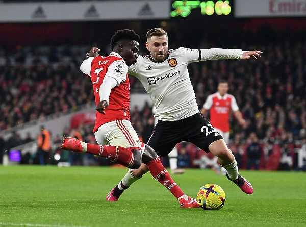 Arsenal's Bukayo Saka Faces Off Against Luke Shaw in Intense Arsenal v Manchester United Clash (2022-23)
