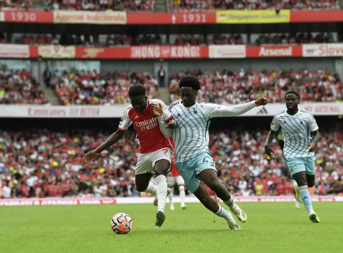 Framed Print : Arsenal's Bukayo Saka Faces Off Against Nottingham Forest's Ola Aina in 2023-24 Premier League Clash Framed Print : Arsenal's Bukayo Saka Faces Off Against Nottingham Forest's Ola Aina in 2023-24 Premier League Clash