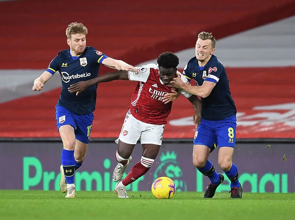 Arsenal's Bukayo Saka Faces Off Against Southampton Duo Armstrong and Ward-Prowse in Emirates Clash (2020-21)
