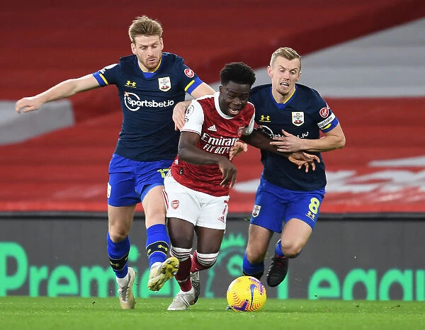 Arsenal's Bukayo Saka Faces Off Against Southampton Duo Armstrong and Ward-Prowse in Emirates Clash (2020-21)