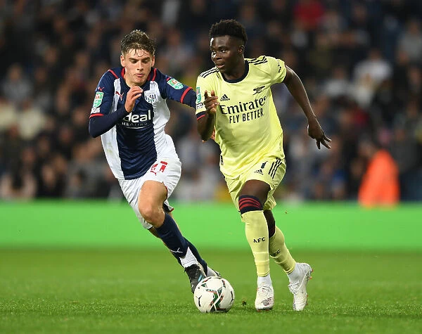 Arsenal's Bukayo Saka Faces Off Against West Bromwich Albion's Tom Fellows in Carabao Cup Clash