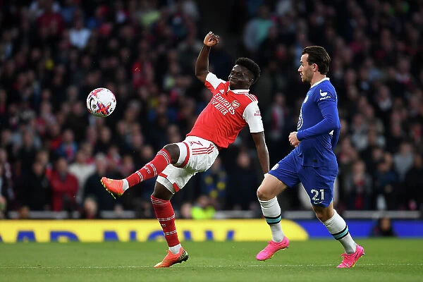 Arsenal's Bukayo Saka Fends Off Chelsea's Ben Chilwell in Intense Premier League Clash