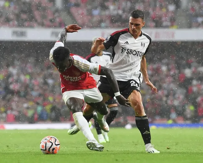 Framed Print : Arsenal's Bukayo Saka Fights for Possession Against Fulham's Joao Palhinha in 2023-24 Premier League Clash