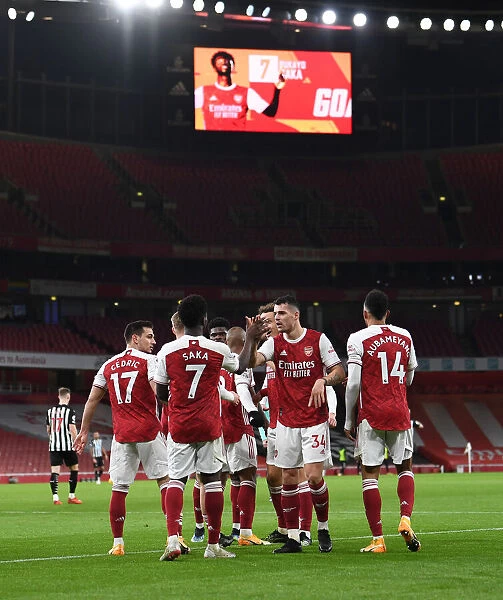 Arsenal's Bukayo Saka and Granit Xhaka Celebrate Goals Amidst Empty Emirates Stadium Against Newcastle United (January 18, 2021)