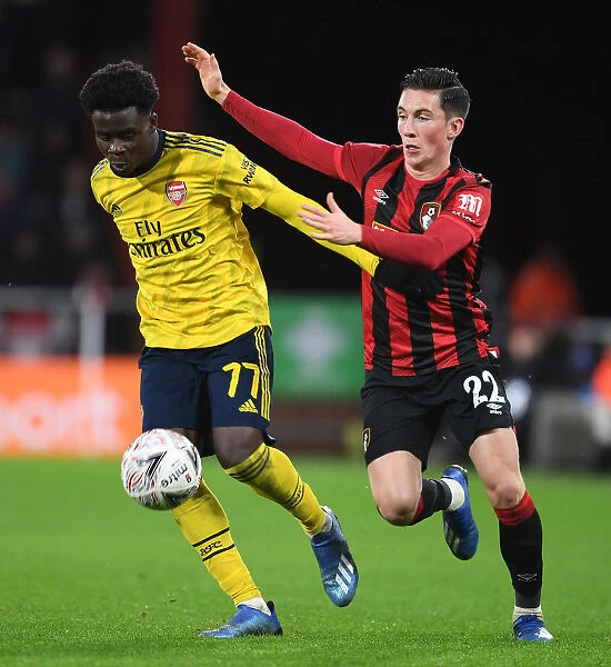Arsenal's Bukayo Saka Outmaneuvers Bournemouth's Harry Wilson in FA Cup Fourth Round Clash
