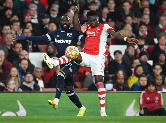 Framed Print : Arsenal's Bukayo Saka Outwits Arthur Masuaku: A Premier League Battle at Emirates Stadium