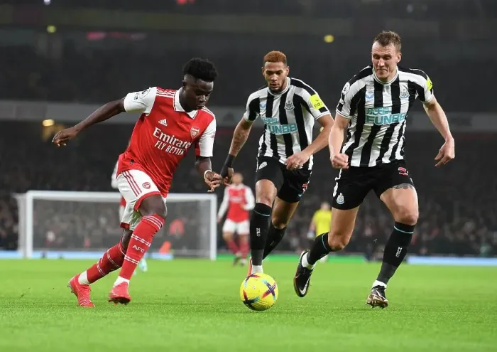 Framed Print : Arsenal's Bukayo Saka Outwits Newcastle's Dan Burn: A Premier League Tactical Battle Framed Print : Arsenal's Bukayo Saka Outwits Newcastle's Dan Burn: A Premier League Tactical Battle