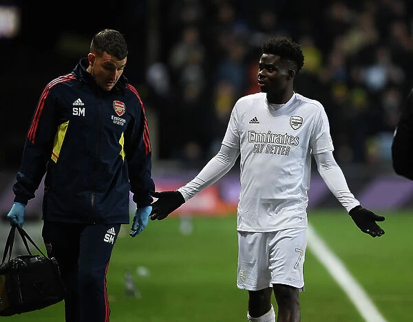 Arsenal's Bukayo Saka Receives Medical Attention from Physio During FA Cup Match against Oxford United