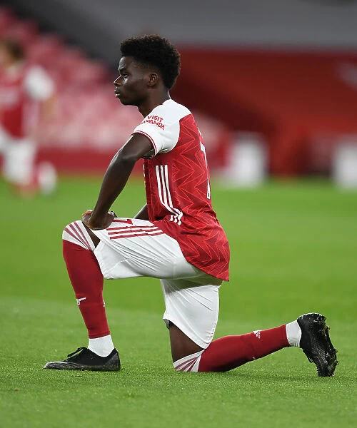 Arsenal's Bukayo Saka Takes a Knee during Emirates Stadium's Empty Ranks: Arsenal v Leicester City, 2020-21 Premier League