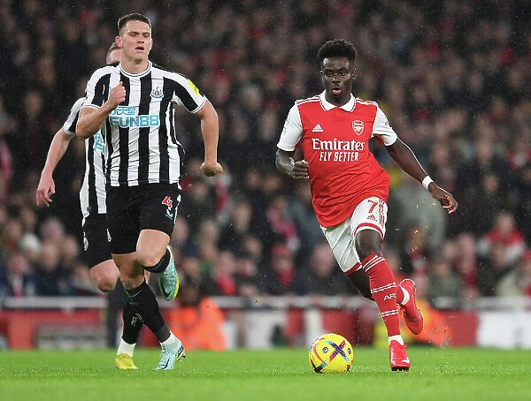 Arsenal's Bukayo Saka Takes on Newcastle's Sven Botman in Premier League Clash