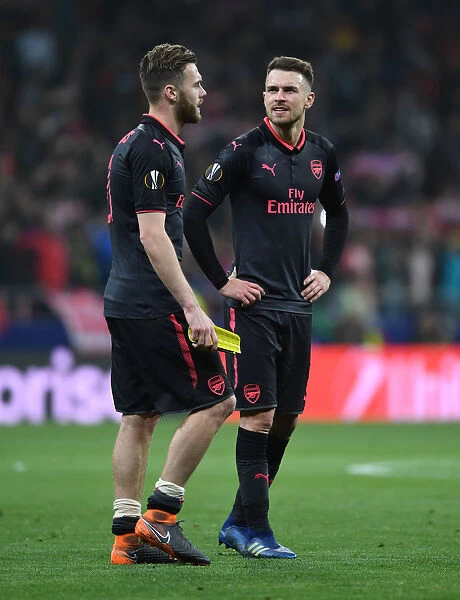 Arsenal's Calum Chambers and Aaron Ramsey: Determination Amidst Defeat in Atletico Madrid Semi-Final