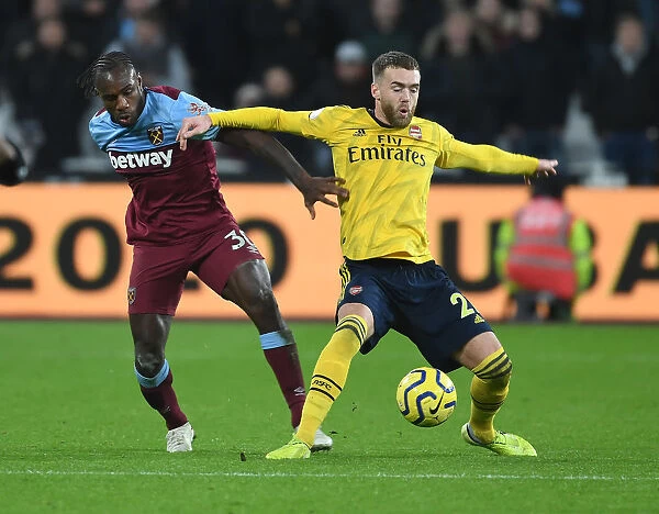 Arsenal's Calum Chambers Fends Off West Ham's Michail Antonio in Premier League Clash