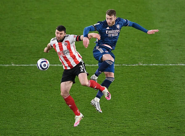 Arsenal's Calum Chambers Fights for Control Against Sheffield United in Premier League Clash