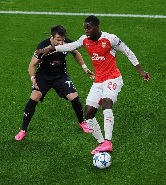 Arsenal's Campbell Fends Off Matel in Champions League Showdown