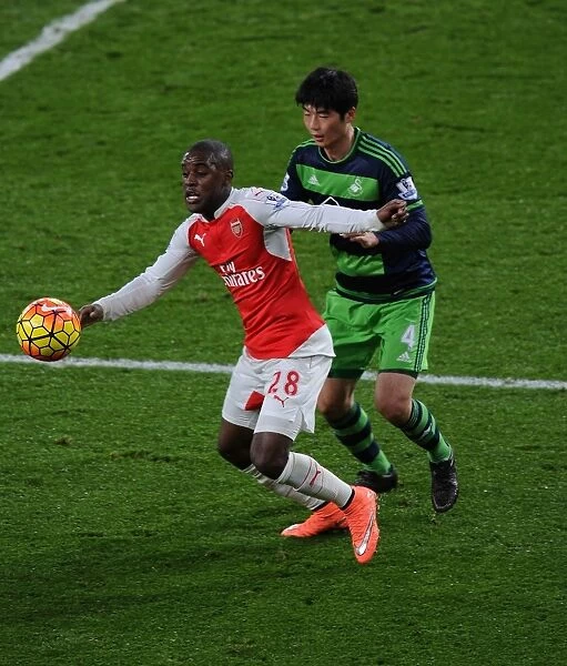 Arsenal's Campbell Fends Off Swansea's Sung-Yueng in Intense Premier League Showdown (2015-16)