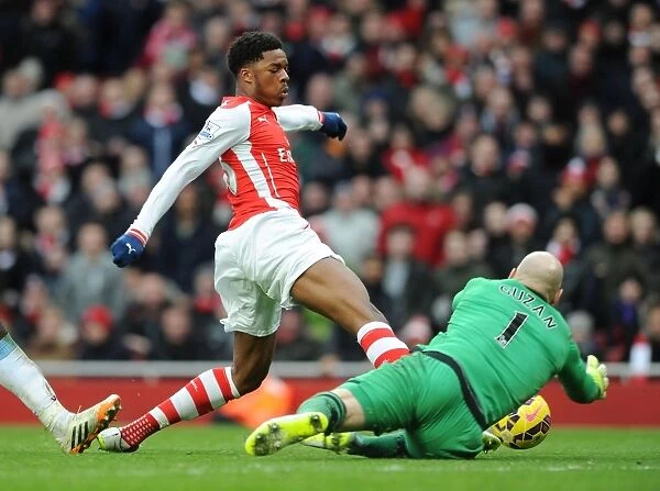 Arsenal's Chuba Akpom Battles Aston Villa's Brad Guzan for Possession in Premier League Clash