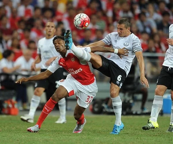 Arsenal's Chuba Akpom Battles Phil Jagielka in Intense Encounter at Barclays Asia Trophy