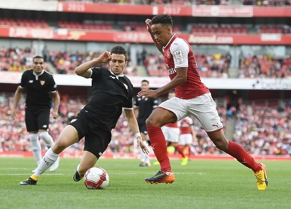 Arsenal's Cohen Bramall Clashes with Sevilla's Sebastien Corchia in Emirates Cup Match