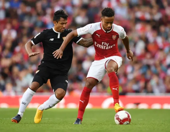 Framed Print : Arsenal's Cohen Bramall Clashes with Sevilla's Walter Montoya during the Emirates Cup Match