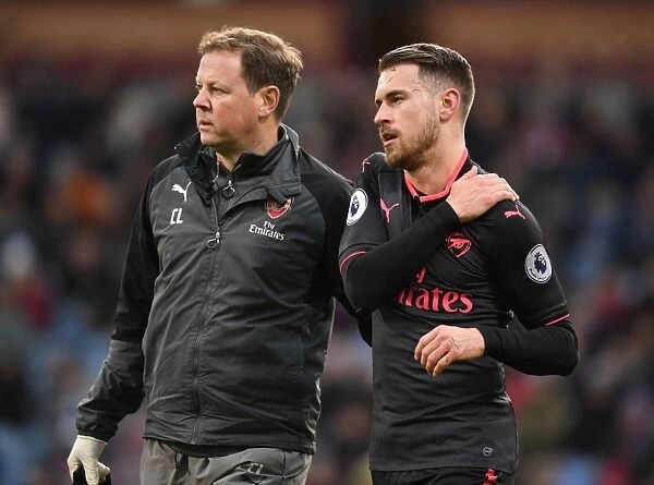 Arsenal's Colin Lewin Attends to Injured Aaron Ramsey during Burnley Match